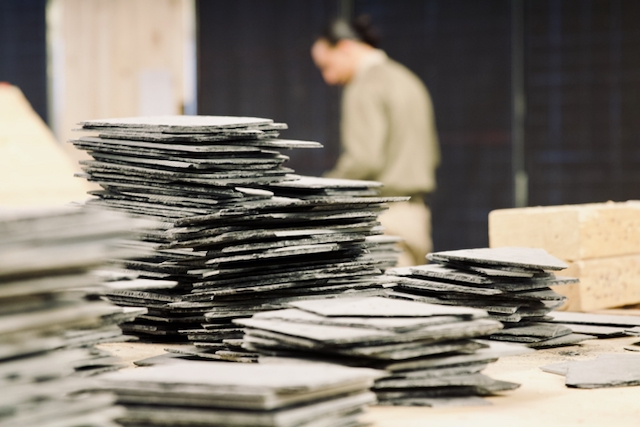 Stacked workpieces and a person working at JVA Heinsberg